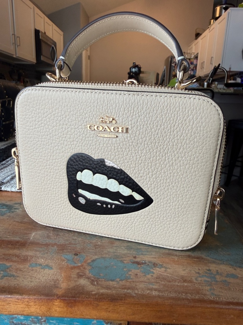 Coach Cream Pebbled Leather Mini Top-Handle Bag with Black Lip Graphic
